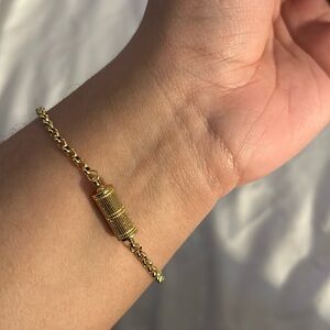 Gold necklace with a barrel